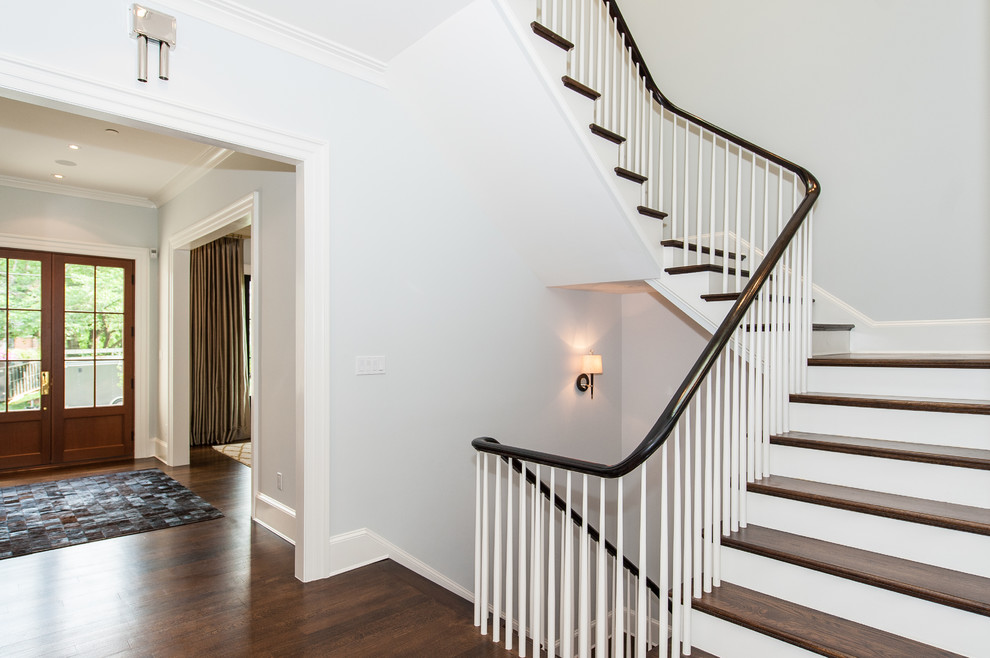 Photo of a large contemporary wood curved staircase in DC Metro with wood risers.