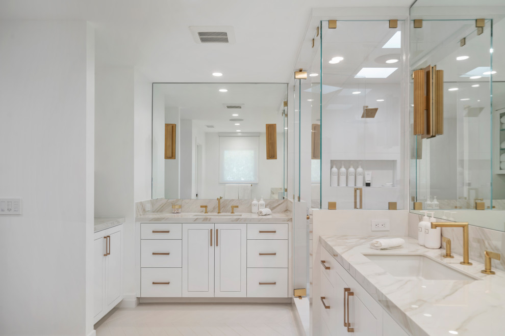 Large trendy master porcelain tile, white floor and double-sink alcove shower photo in Los Angeles with flat-panel cabinets, white cabinets, white walls, an undermount sink, solid surface countertops, multicolored countertops, a niche and a built-in vanity