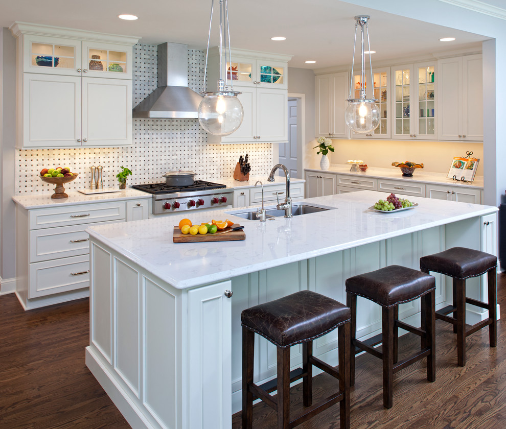Inspiration for a large transitional galley dark wood floor open concept kitchen remodel in Minneapolis with an undermount sink, recessed-panel cabinets, white cabinets, quartzite countertops, white backsplash, mosaic tile backsplash, stainless steel appliances and an island