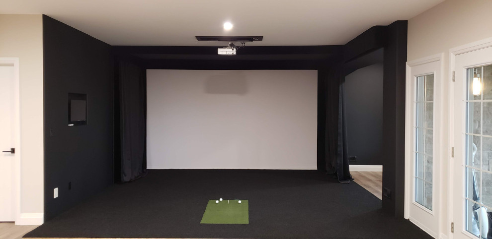 Large traditional walk-out basement in Other with a game room and black floors.