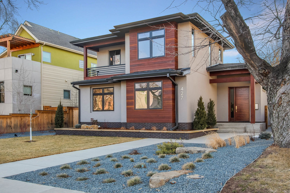Inspiration for a transitional two-storey house exterior in Denver with mixed siding.