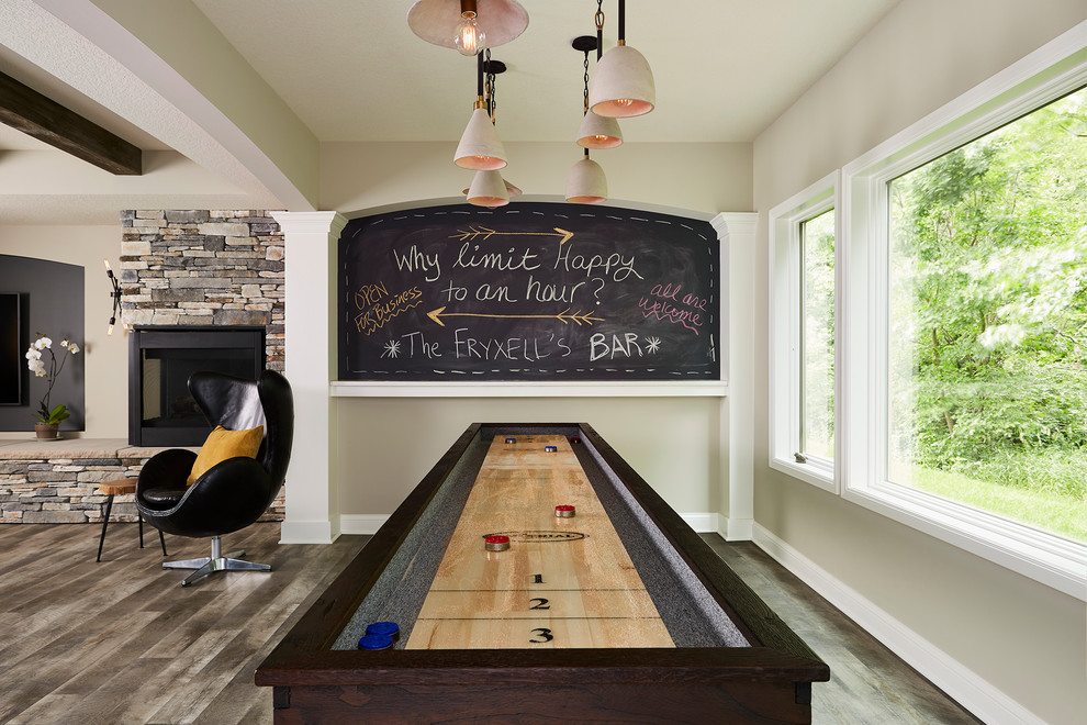 Design ideas for a large transitional open concept family room in Minneapolis with a game room, grey walls, vinyl floors, a corner fireplace, a stone fireplace surround, a wall-mounted tv and grey floor.