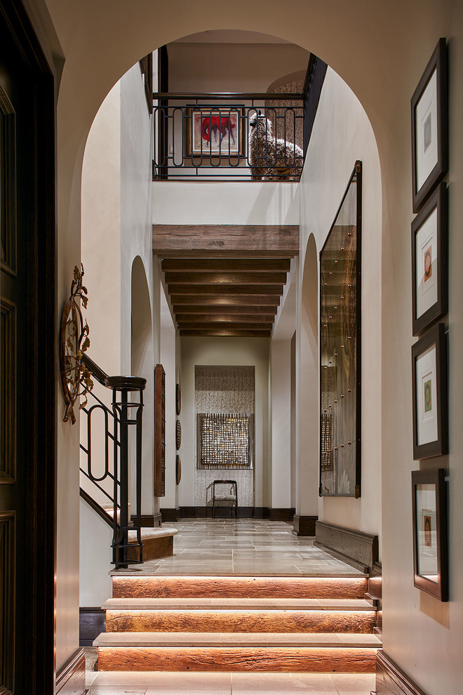 Photo of an expansive transitional foyer in Dallas with limestone floors, beige floor and grey walls.
