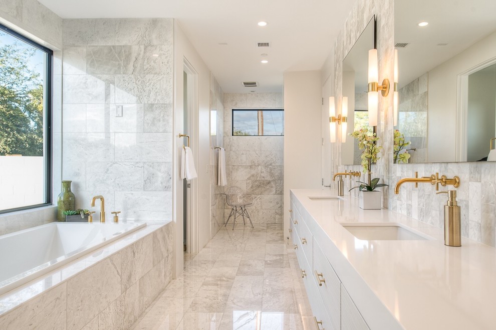 Design ideas for a mid-sized contemporary master bathroom in Phoenix with an undermount sink, flat-panel cabinets, engineered quartz benchtops, a drop-in tub, stone tile, marble floors, white cabinets, an alcove shower and white tile.