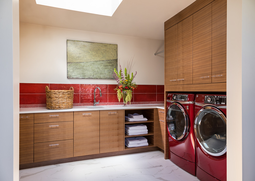 Inspiration for a mid-sized contemporary l-shaped dedicated laundry room in Albuquerque with an undermount sink, flat-panel cabinets, medium wood cabinets, beige walls, marble floors, a side-by-side washer and dryer and white floor.