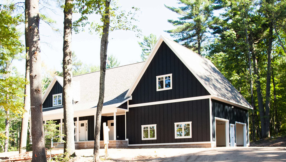 This is an example of a country two-storey blue exterior in Other with wood siding and a gable roof.