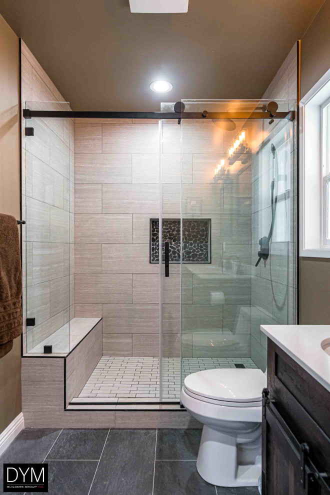 Photo of a mid-sized contemporary master bathroom in Orange County with furniture-like cabinets, dark wood cabinets, an alcove shower, a one-piece toilet, brown tile, wood-look tile, brown walls, cement tiles, a drop-in sink, solid surface benchtops, grey floor, a sliding shower screen, white benchtops, a double vanity, a built-in vanity, wallpaper and wallpaper.