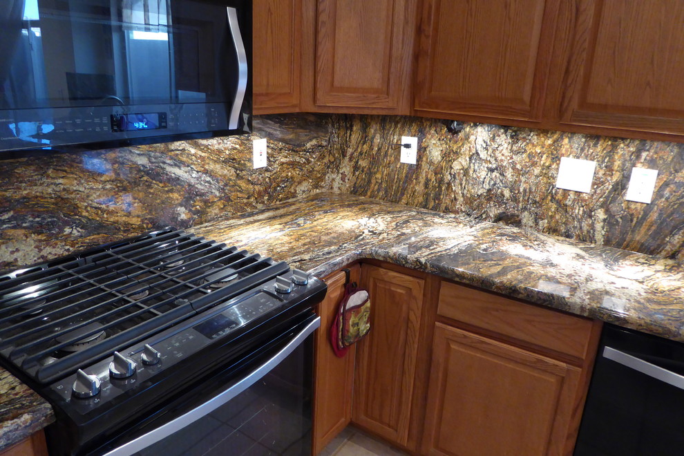 Inspiration for a ceramic tile eat-in kitchen remodel in Phoenix with an undermount sink, light wood cabinets, granite countertops, black appliances and an island