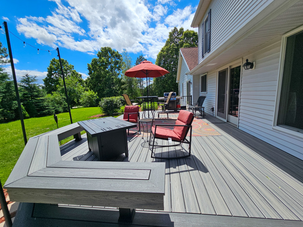 Inspiration for a mid-sized transitional backyard metal railing deck remodel with a bbq area