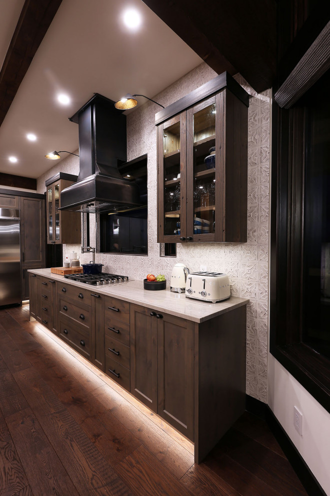 Large mountain style l-shaped medium tone wood floor and brown floor open concept kitchen photo in Vancouver with an undermount sink, shaker cabinets, medium tone wood cabinets, granite countertops, white backsplash, porcelain backsplash, stainless steel appliances, an island and white countertops