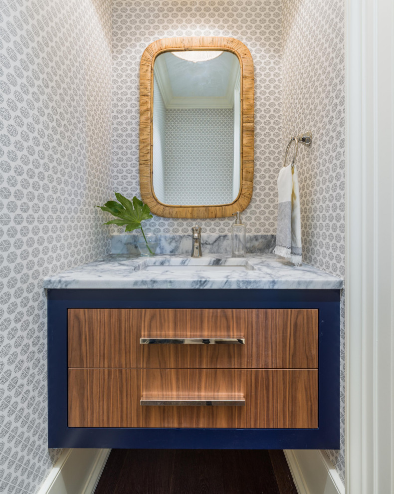 Beach style powder room photo in Charleston with brown cabinets and a built-in vanity