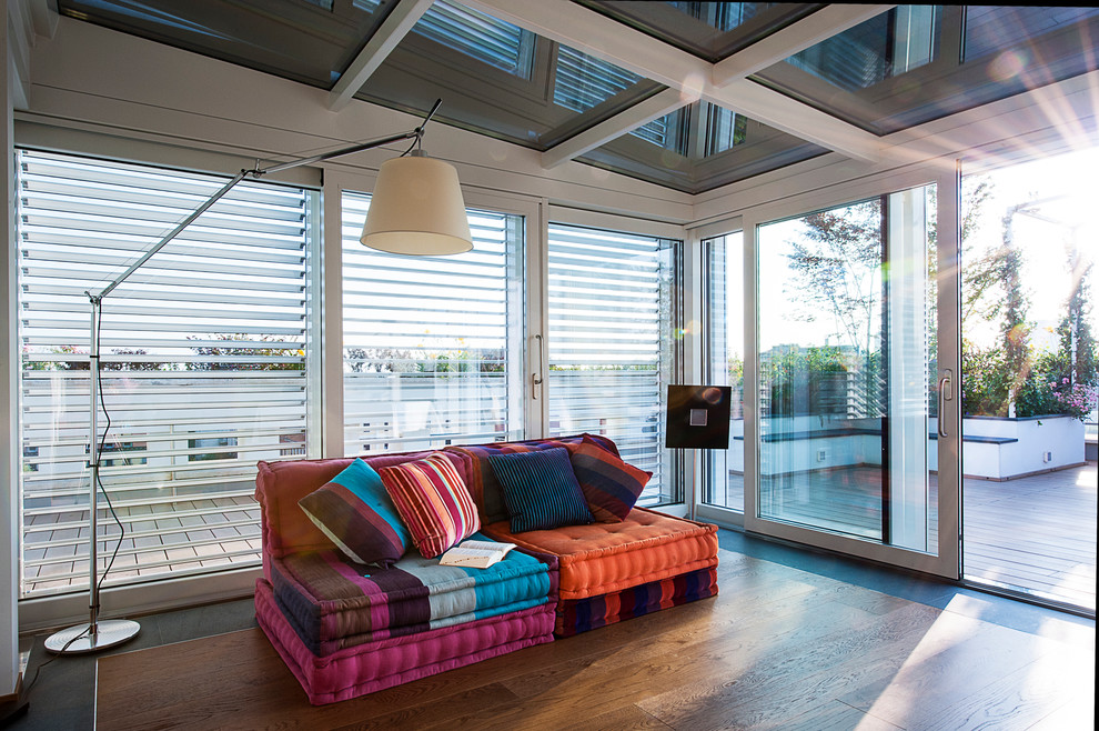 Mid-sized contemporary sunroom in Milan with medium hardwood floors and a skylight.