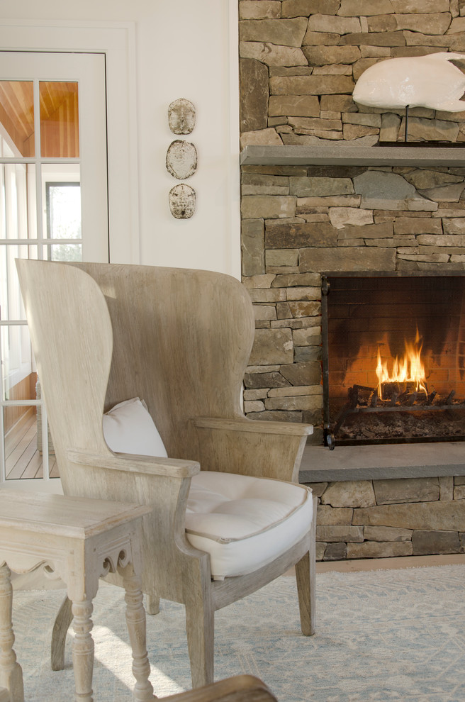 Photo of a transitional living room in Boston with white walls, a standard fireplace and a stone fireplace surround.
