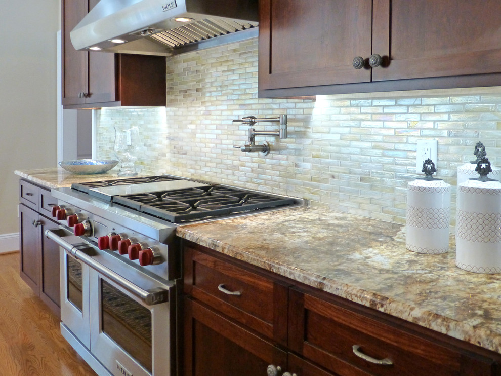 Kitchen - large transitional medium tone wood floor kitchen idea in Richmond with recessed-panel cabinets, dark wood cabinets, granite countertops, beige backsplash, ceramic backsplash, stainless steel appliances and an island