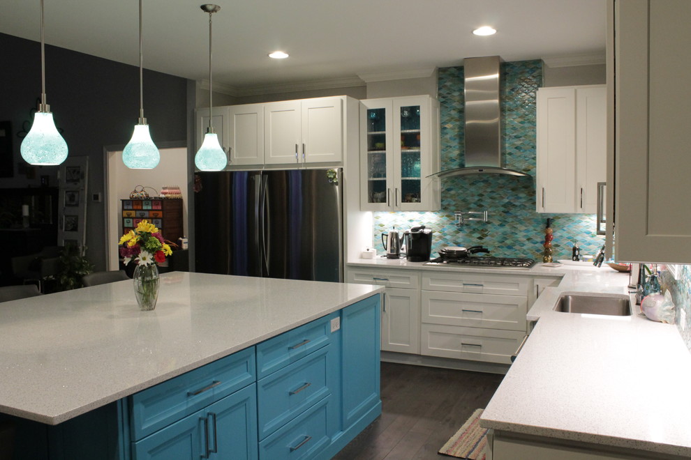 This is an example of a transitional eat-in kitchen in Other with an undermount sink, flat-panel cabinets, turquoise cabinets, solid surface benchtops, blue splashback, glass tile splashback, stainless steel appliances, with island and white benchtop.