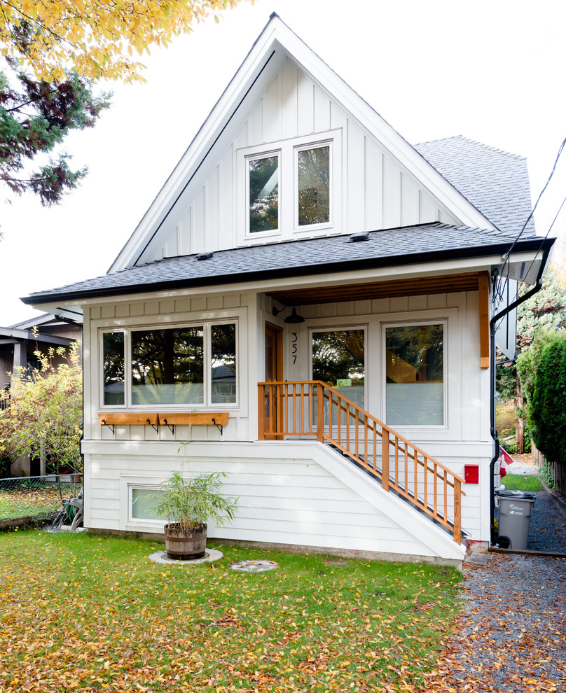 Inspiration for a traditional two-storey white exterior in Vancouver with a gable roof.