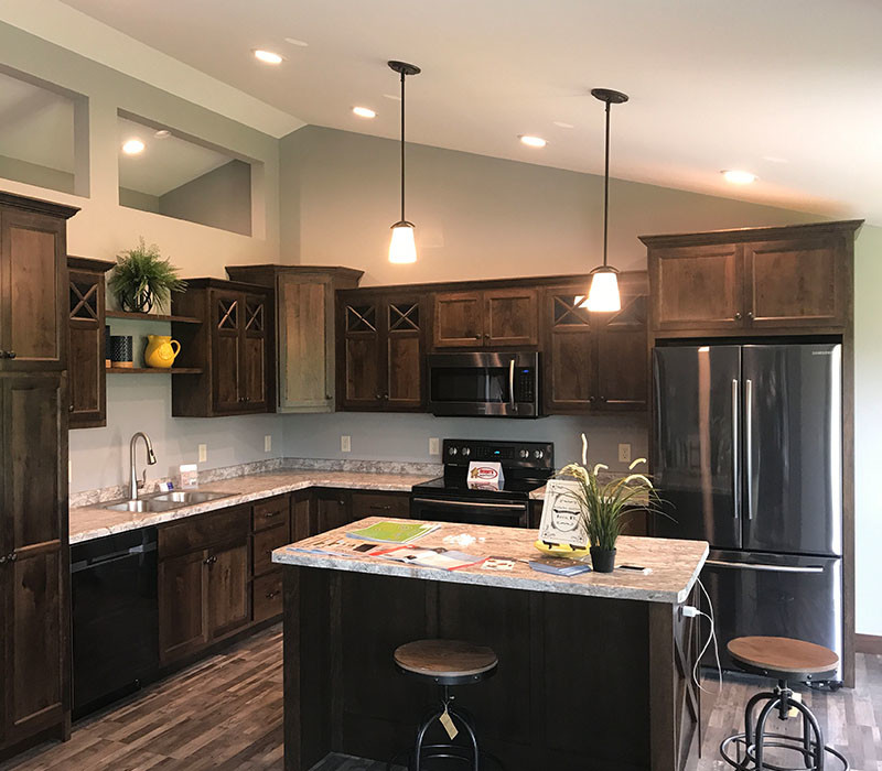 Inspiration for a mid-sized rustic l-shaped dark wood floor and brown floor eat-in kitchen remodel in Minneapolis with a double-bowl sink, recessed-panel cabinets, dark wood cabinets, granite countertops, stainless steel appliances, an island and gray countertops