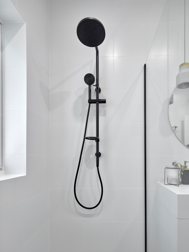 This is an example of a mid-sized contemporary 3/4 bathroom in Other with an open shower, a two-piece toilet, white tile, porcelain tile, white walls, porcelain floors, an integrated sink, grey floor, an open shower, flat-panel cabinets, white cabinets, solid surface benchtops and white benchtops.