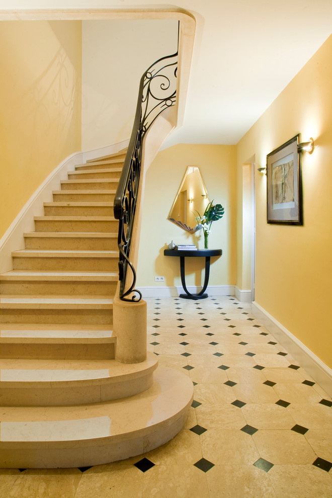 This is an example of a large transitional concrete curved staircase in Other.