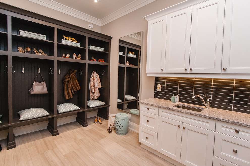 Photo of a transitional laundry room in Toronto with recessed-panel cabinets, white cabinets and a side-by-side washer and dryer.