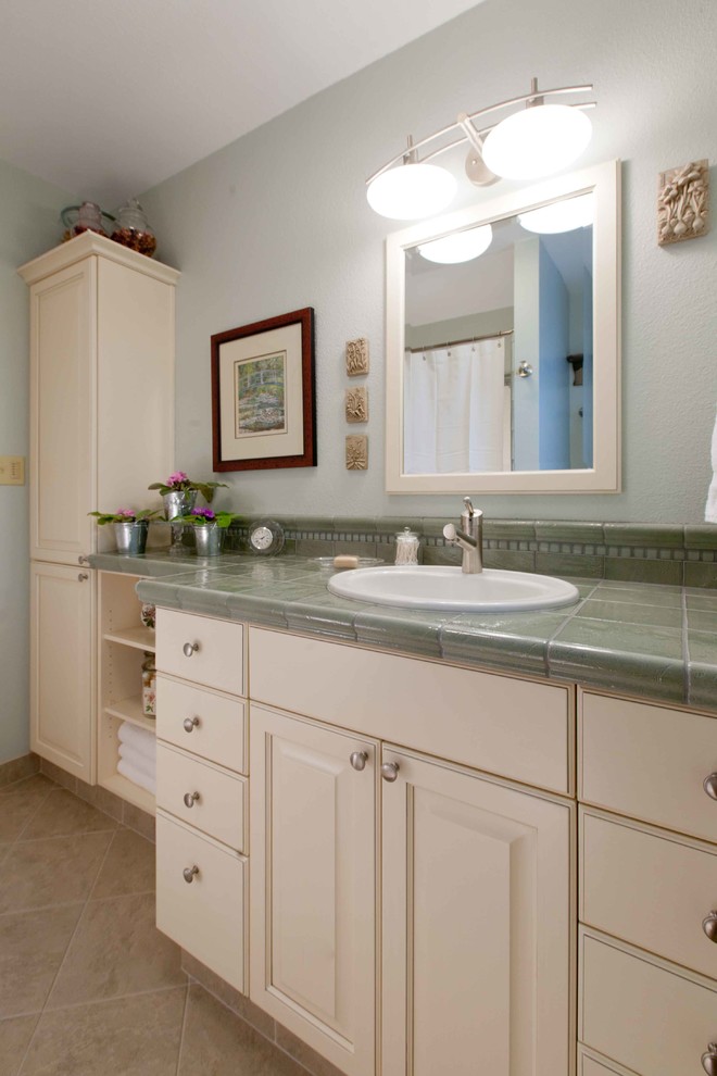 Example of a mid-sized transitional master brown tile and ceramic tile porcelain tile freestanding bathtub design in Seattle with a vessel sink, recessed-panel cabinets, white cabinets, granite countertops, a two-piece toilet and gray walls