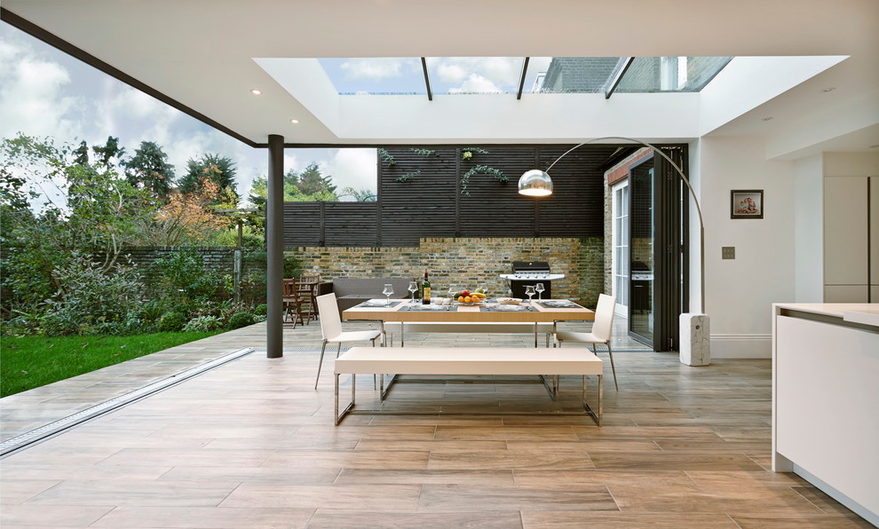Contemporary dining room in London with light hardwood floors.