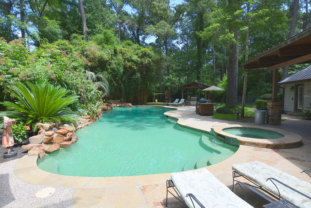 This is an example of an expansive traditional backyard custom-shaped pool in Houston.