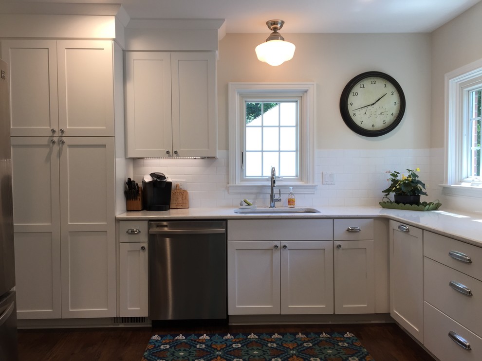 Mid-sized transitional u-shaped eat-in kitchen photo in Grand Rapids with flat-panel cabinets, white cabinets, quartz countertops, white backsplash, subway tile backsplash, stainless steel appliances, a peninsula and white countertops