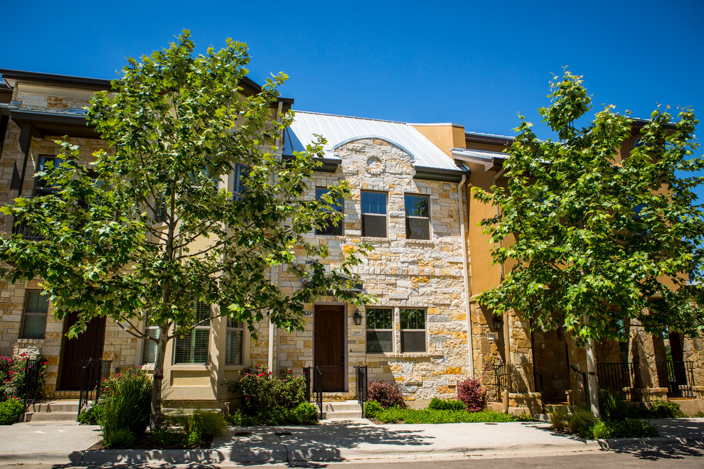 Inspiration for a huge transitional beige three-story stone exterior home remodel in Austin with a hip roof