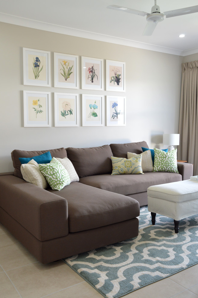Small transitional enclosed living room in Townsville with beige walls and ceramic floors.