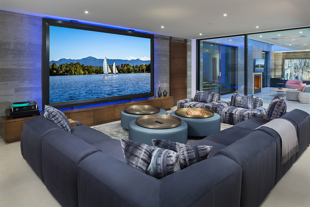 Design ideas for a beach style open concept home theatre in Indianapolis with grey walls, a projector screen and grey floor.