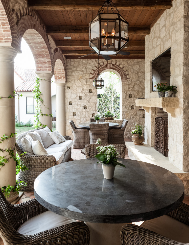Mediterranean patio in Dallas with a fire feature.
