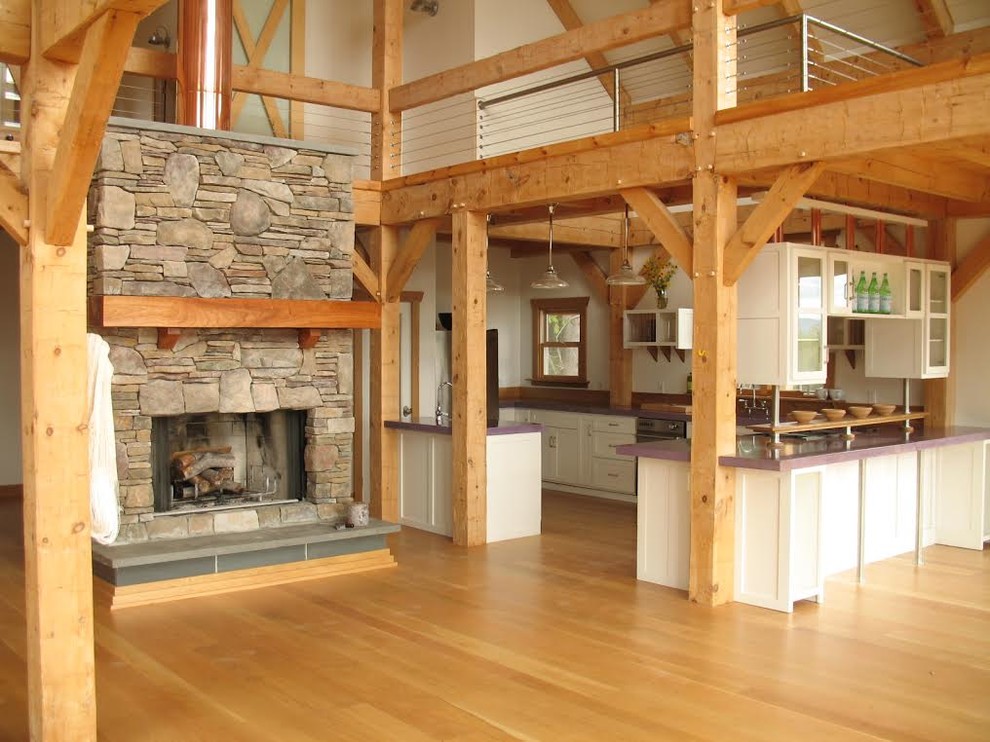 Example of a large mountain style u-shaped light wood floor open concept kitchen design with glass-front cabinets, white cabinets, solid surface countertops, white backsplash, a peninsula and purple countertops