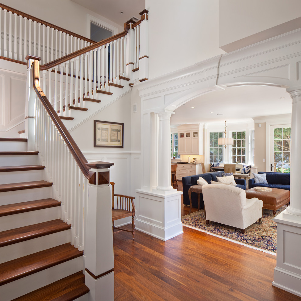 Design ideas for a traditional foyer in Boston with white walls and dark hardwood floors.