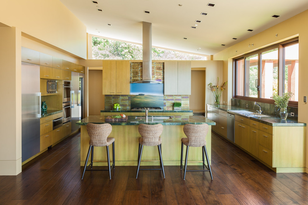 Photo of a large contemporary u-shaped separate kitchen in San Francisco with flat-panel cabinets, light wood cabinets, stainless steel appliances, an undermount sink, granite benchtops, metallic splashback, metal splashback, dark hardwood floors and with island.