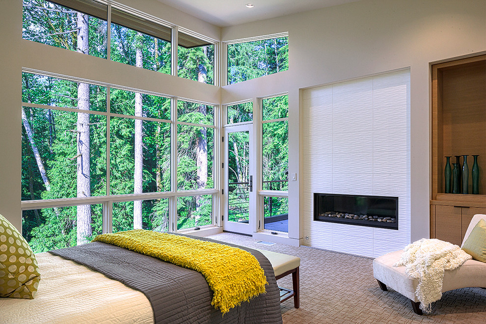 Inspiration for a contemporary master bedroom in Seattle with beige walls and a tile fireplace surround.