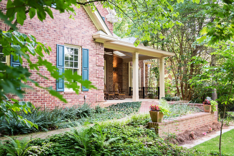 This is an example of a mid-sized traditional front yard verandah in Atlanta with a roof extension.