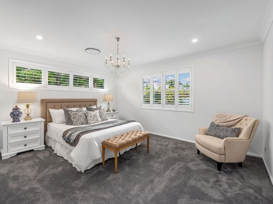 Inspiration for a large transitional master bedroom in Brisbane with white walls, carpet and grey floor.