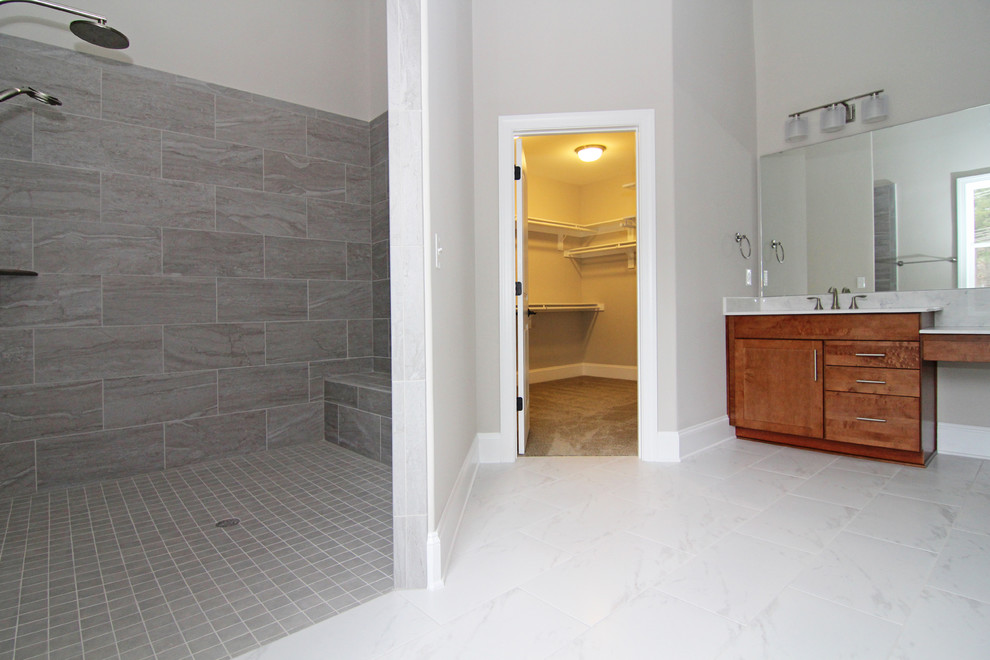 Large contemporary master bathroom in Raleigh with shaker cabinets, medium wood cabinets, an open shower, a one-piece toilet, white tile, ceramic tile, grey walls, ceramic floors, an integrated sink and solid surface benchtops.