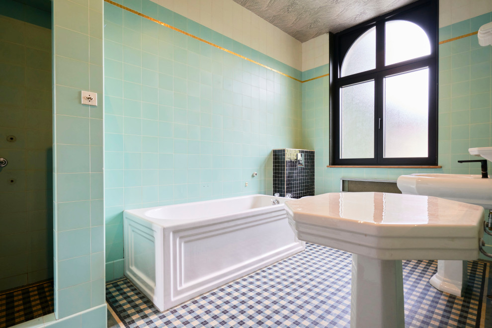 Photo of a small midcentury bathroom in Paris with a built-in bath, green tiles, terracotta tiles, green walls, a pedestal sink, grey floors, white worktops and double sinks.