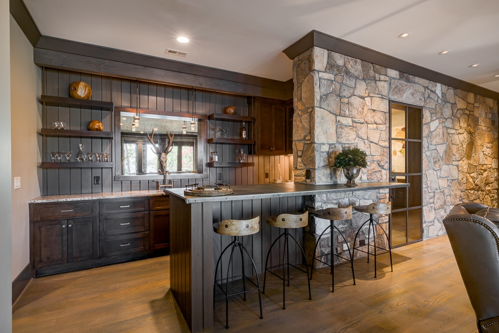 Photo of a country seated home bar in Other with open cabinets, dark wood cabinets and medium hardwood floors.