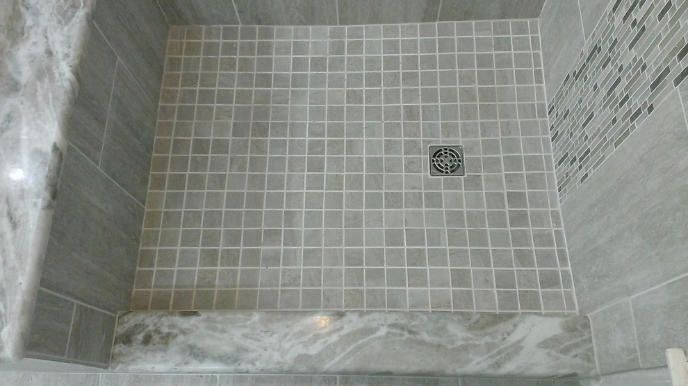 Example of a mid-sized trendy master gray tile and porcelain tile porcelain tile corner shower design in Austin with beaded inset cabinets