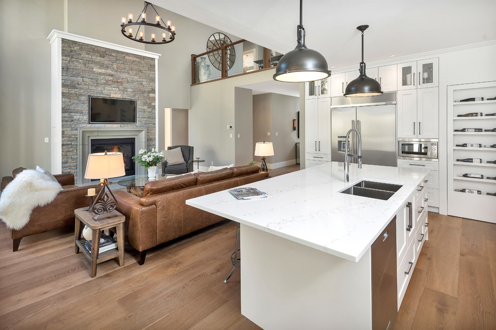 Example of a transitional l-shaped medium tone wood floor and brown floor kitchen design