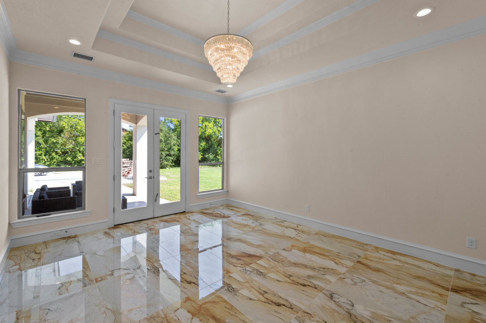 This is an example of a large mediterranean master bedroom in Dallas with beige walls, marble floors, beige floor and recessed.