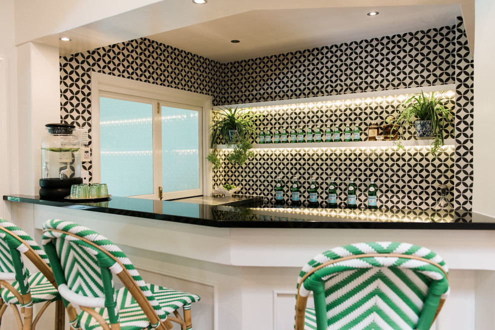 Photo of a large transitional u-shaped seated home bar in Brisbane with recessed-panel cabinets, white cabinets, laminate benchtops, black splashback, ceramic splashback and dark hardwood floors.