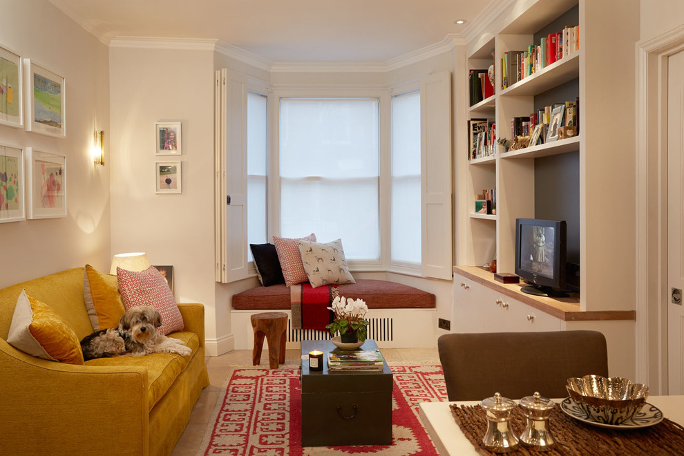 This is an example of a transitional formal enclosed living room in London with white walls and a freestanding tv.