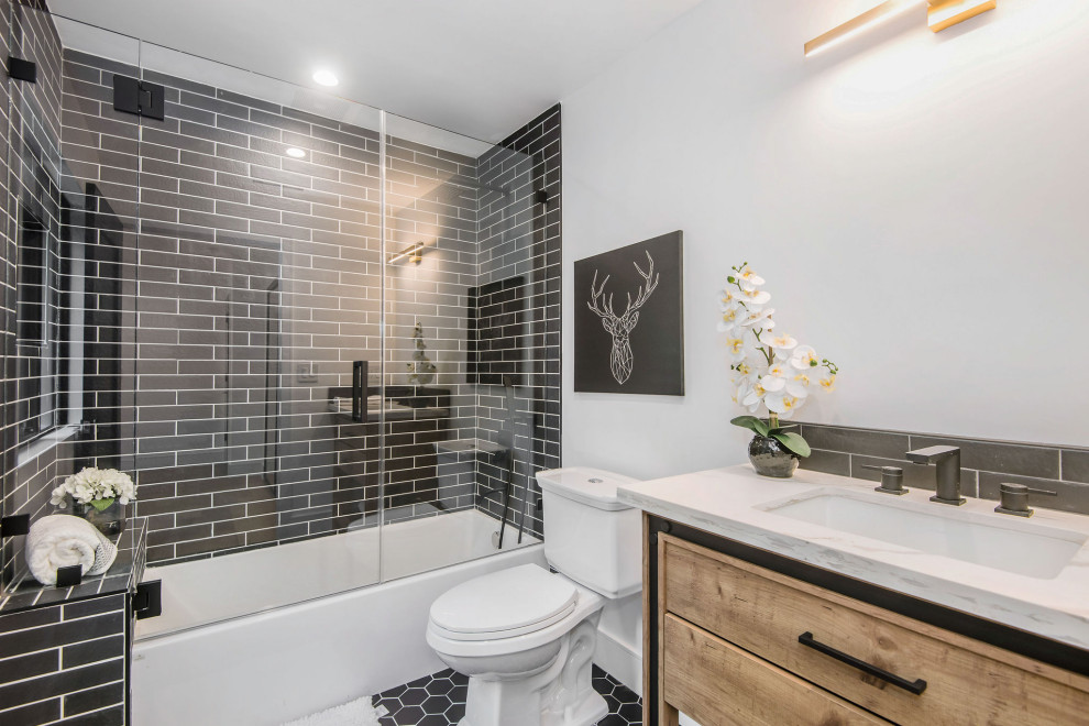 Example of a transitional 3/4 subway tile multicolored floor and single-sink alcove bathtub design in Los Angeles with flat-panel cabinets, medium tone wood cabinets, a two-piece toilet, white walls, an undermount sink, a hinged shower door, multicolored countertops and a built-in vanity