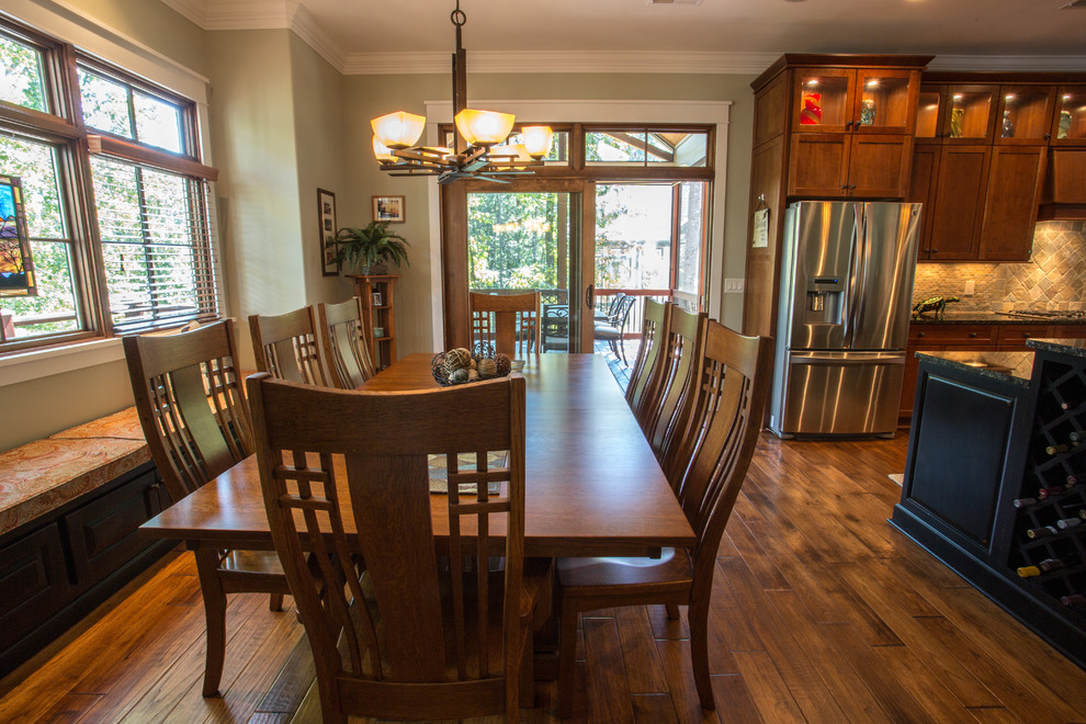 This is an example of a large transitional kitchen/dining combo with beige walls, medium hardwood floors and no fireplace.