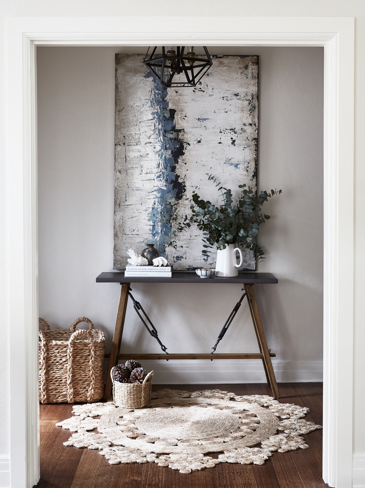 Inspiration for a transitional entry hall in Melbourne with grey walls, dark hardwood floors and brown floor.