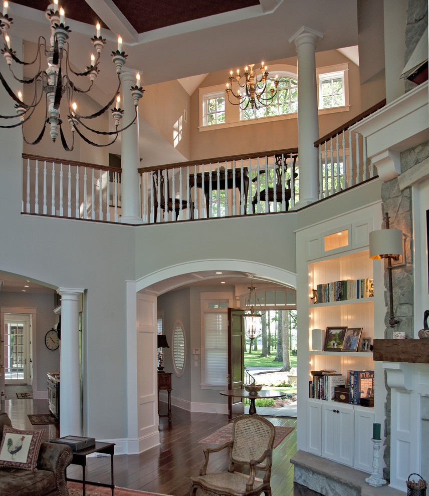 This is an example of a large traditional foyer in Other with beige walls, a single front door and a dark wood front door.